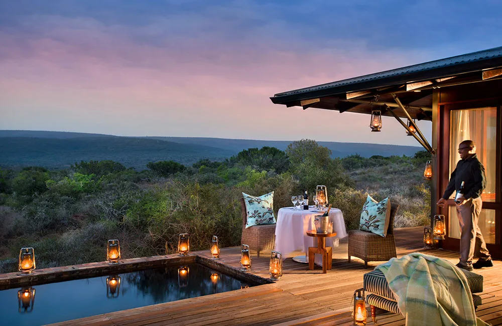 Sunset private dining setup beside a lantern-rimmed plunge pool