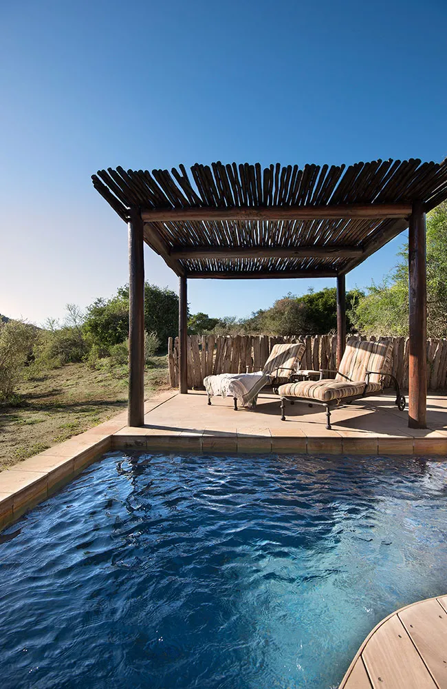 A suite's private plunge pool under a reed-shaded pergola
