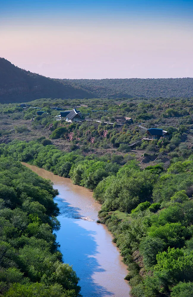 Aerial of the Great Fish River winding through Kwandwe with the lodge perched above