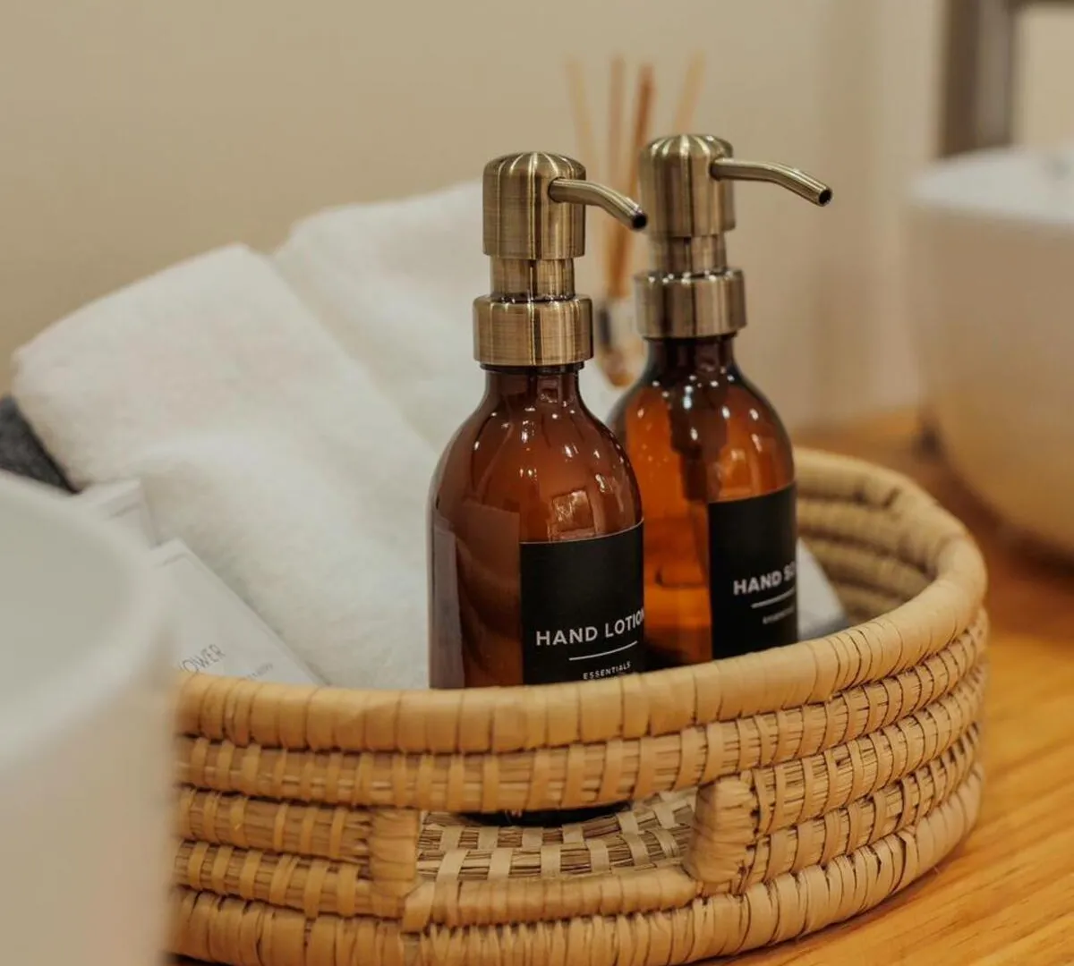 Induli suite bathroom amenities — hand lotion and soap in a woven basket