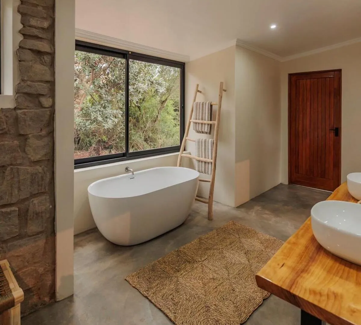 En-suite bathroom with deep freestanding tub and bushveld views