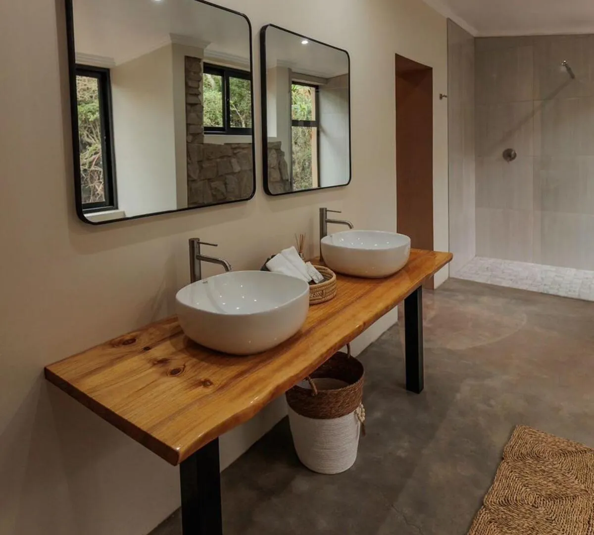 Twin basins on a live-edge wood counter with walk-in shower