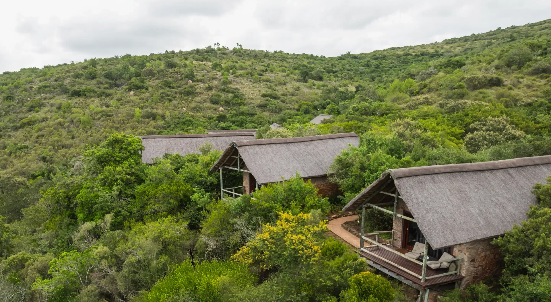 Sunset aerial of Lentaba Lodge thatched chalets in the bush