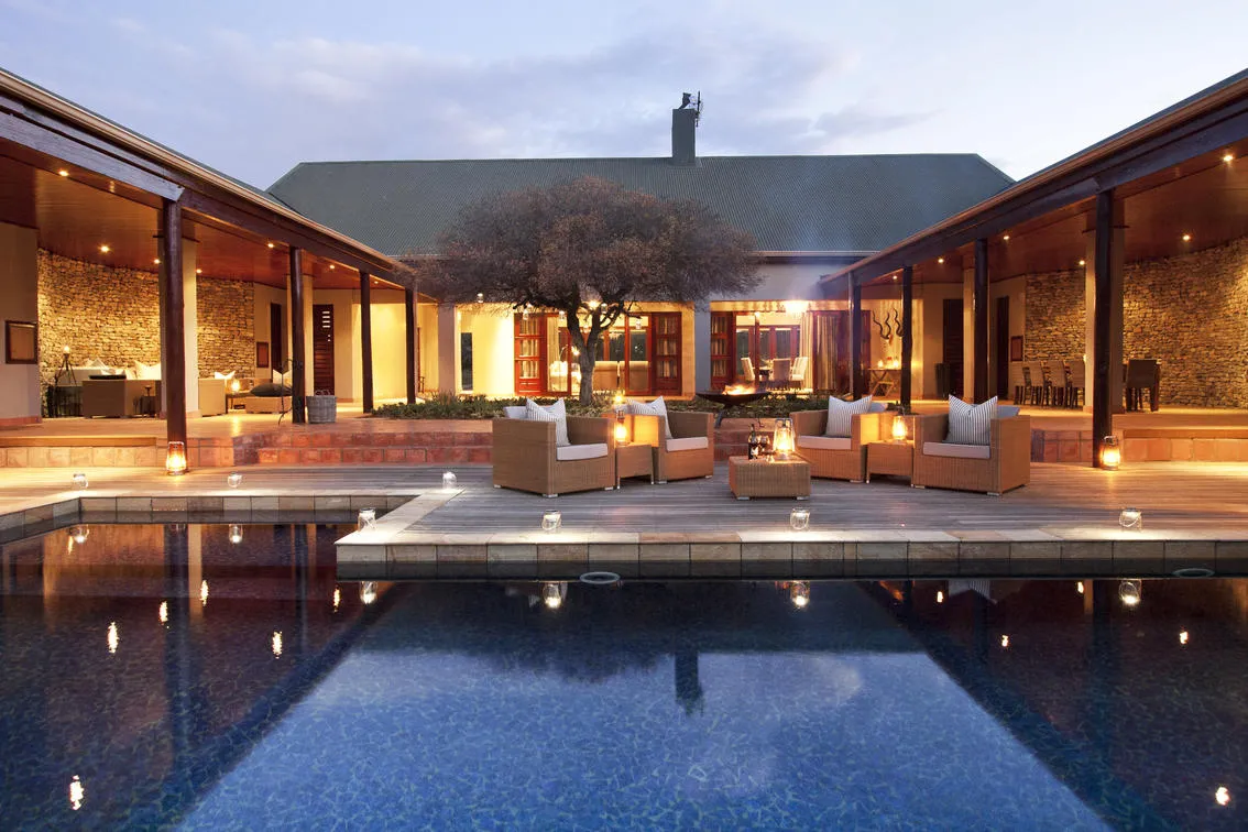 The U-shaped Melton Manor villa at twilight with the central courtyard pool