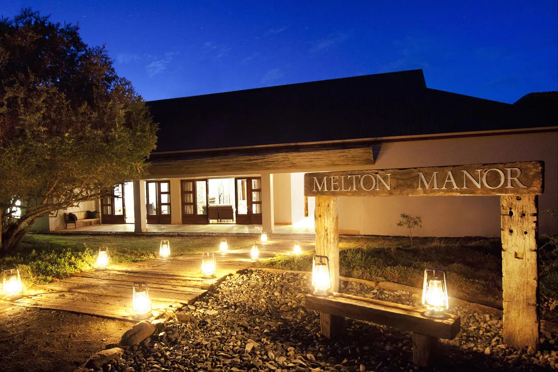 Lantern-lit entrance to Melton Manor at night