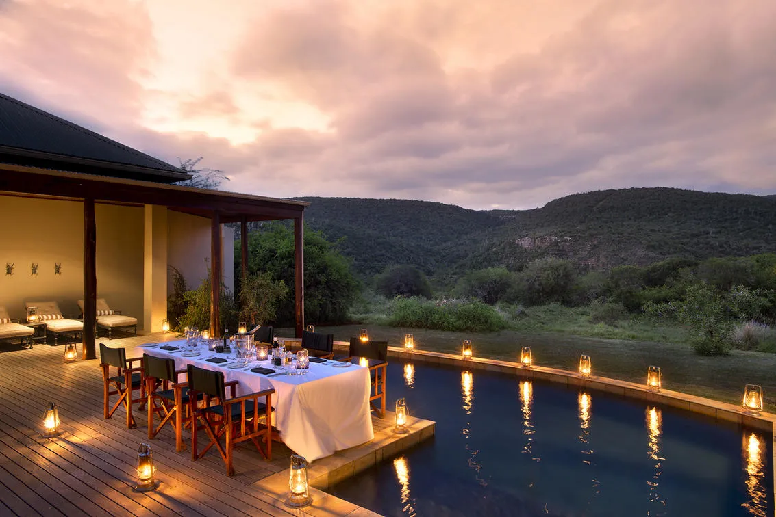 Sunset dining setup on the outdoor deck overlooking the Kwandwe valley