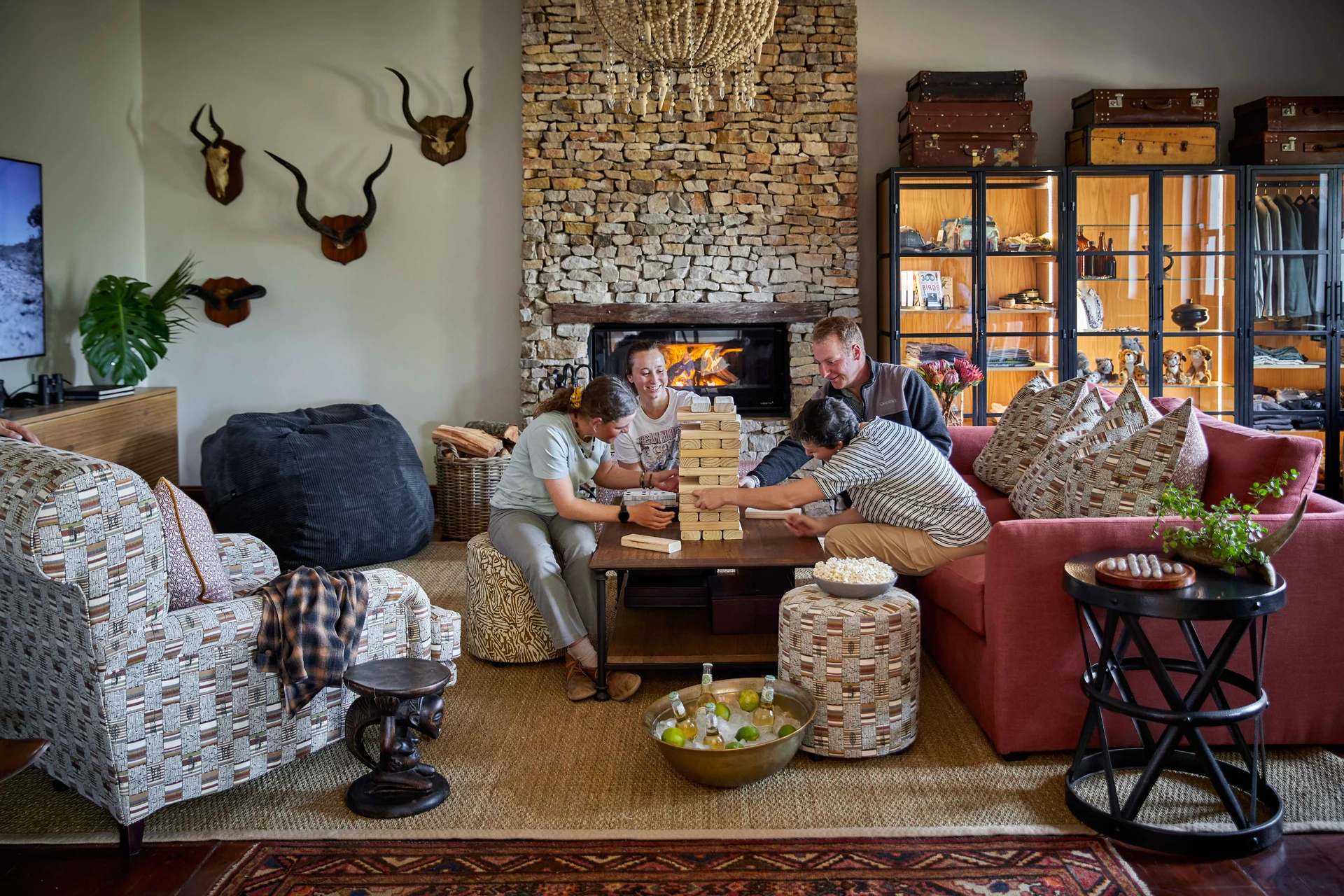 Family playing games together in the lounge by the stone fireplace
