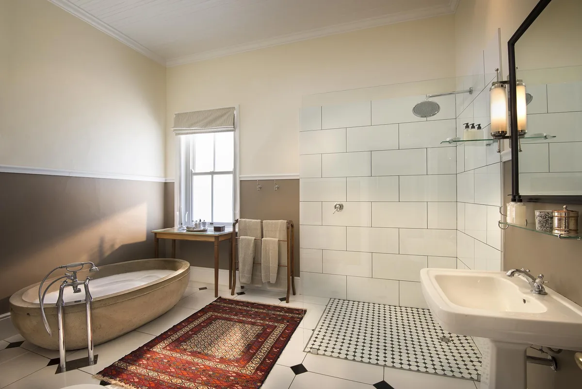 En-suite bathroom with concrete free-standing bath and walk-in shower