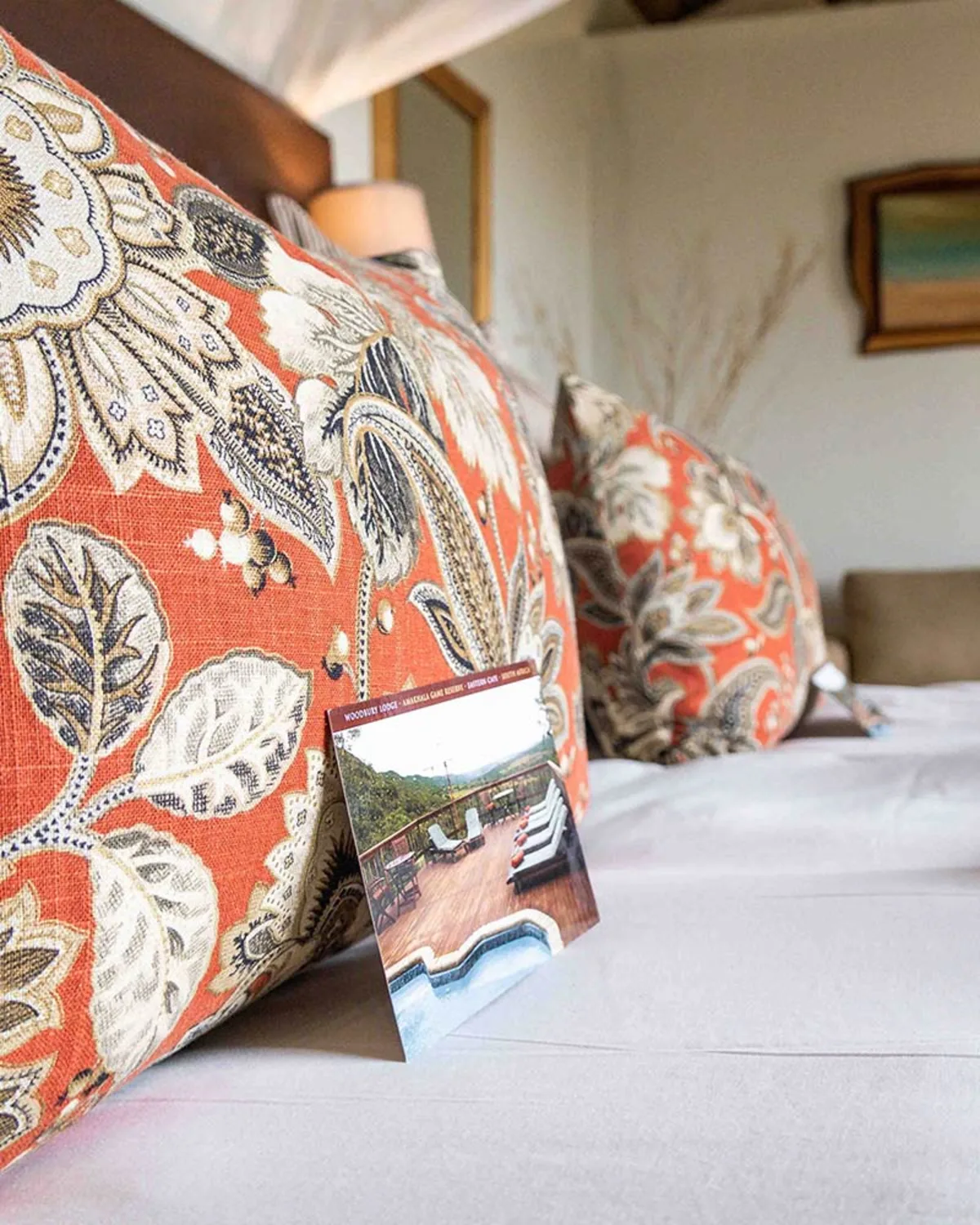 Inside a Woodbury chalet — king bed, en-suite, paisley scatter cushions