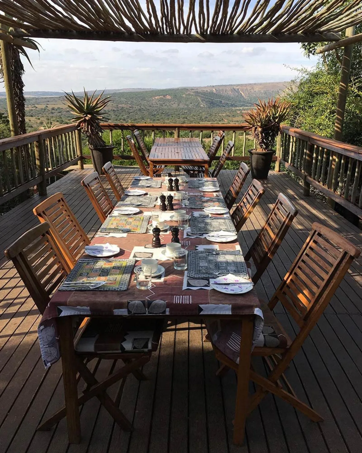 Dining table set on the deck with panoramic valley views